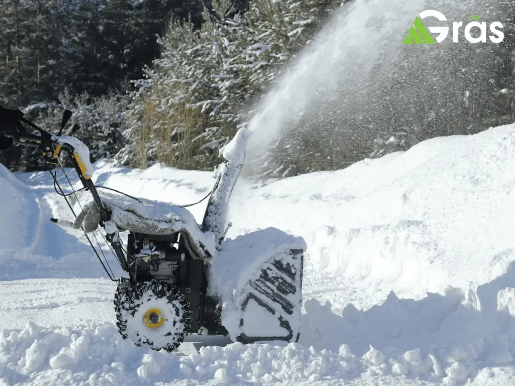 Snow blower clearing heavy snow on a driveway